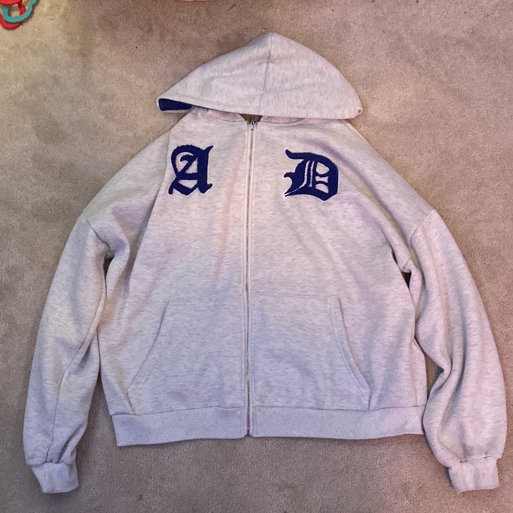 white and blue AD zip up hoodie.